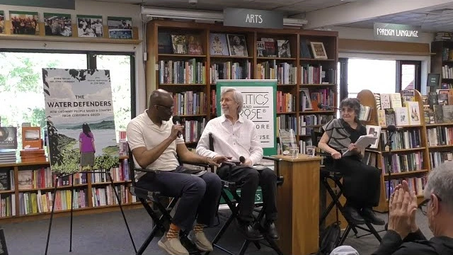 Tope Folarin, John Cavanagh, and Robin Broad seated together in conversation at Politics and Prose.